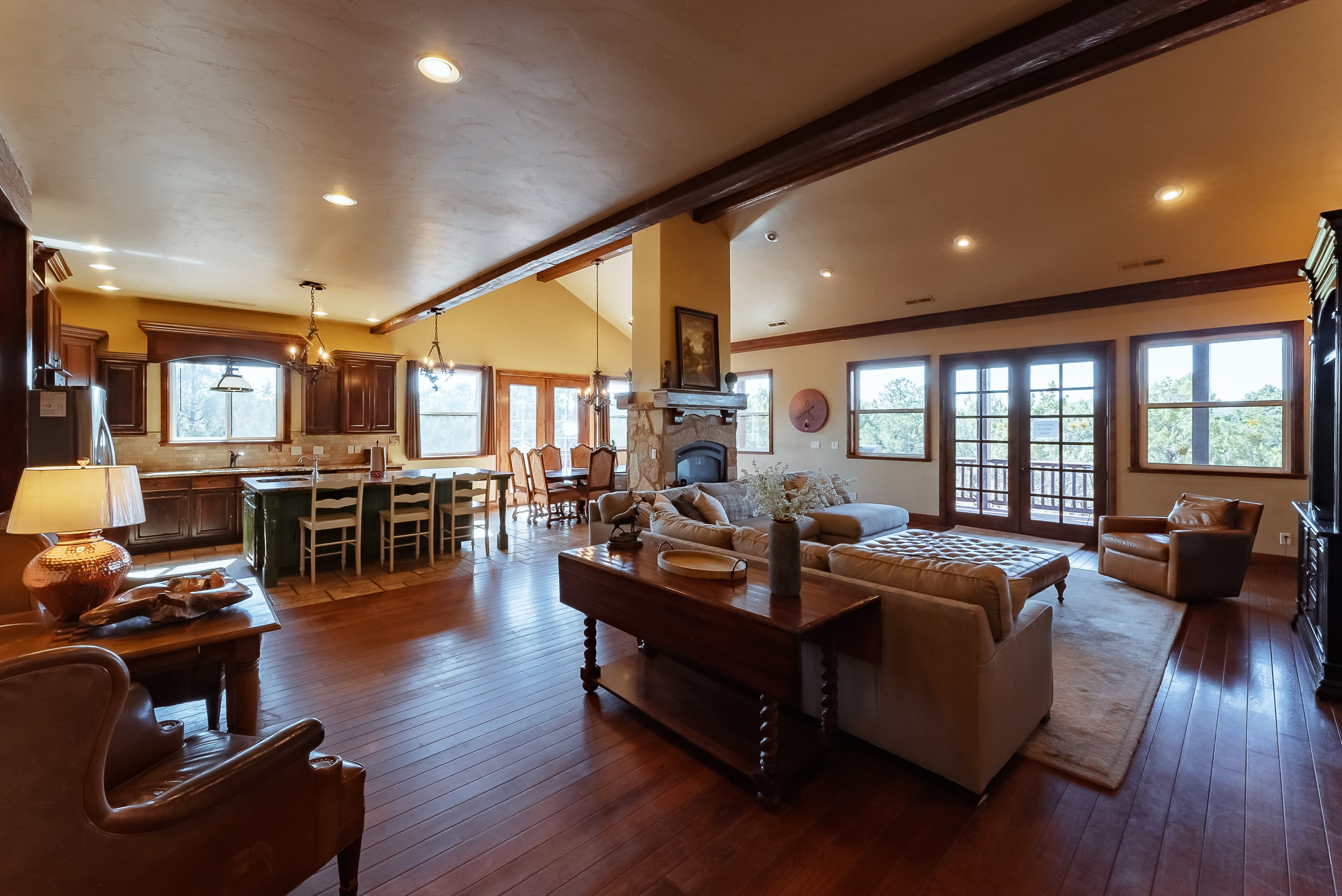 A spacious, modern living area with a cozy seating arrangement and large windows overlooking the outdoors.