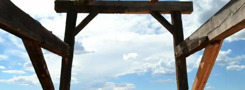 Wooden structure against a cloudy blue sky.