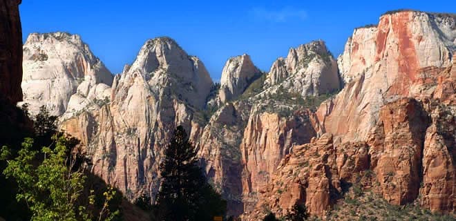 Majestic, steep rock formations under a clear blue sky.