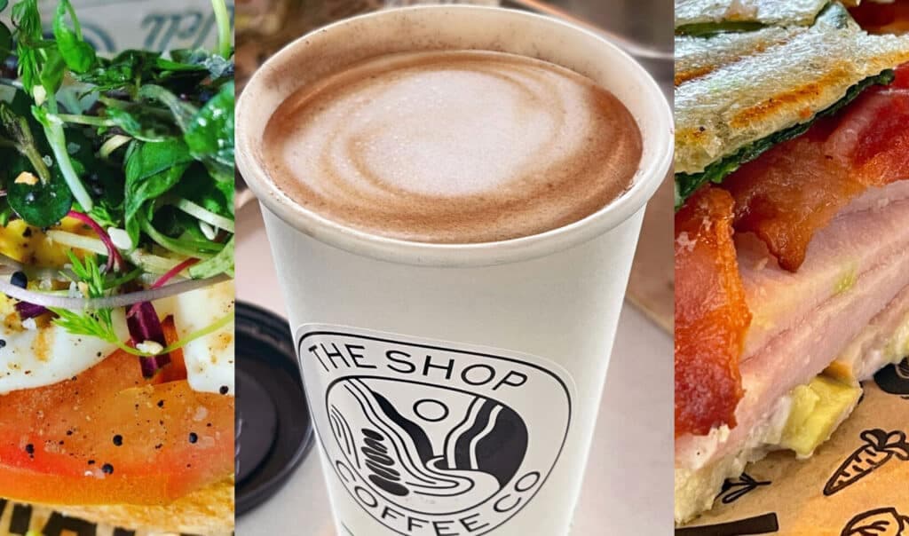A cappuccino flanked by a colorful sandwich and a fresh salad.