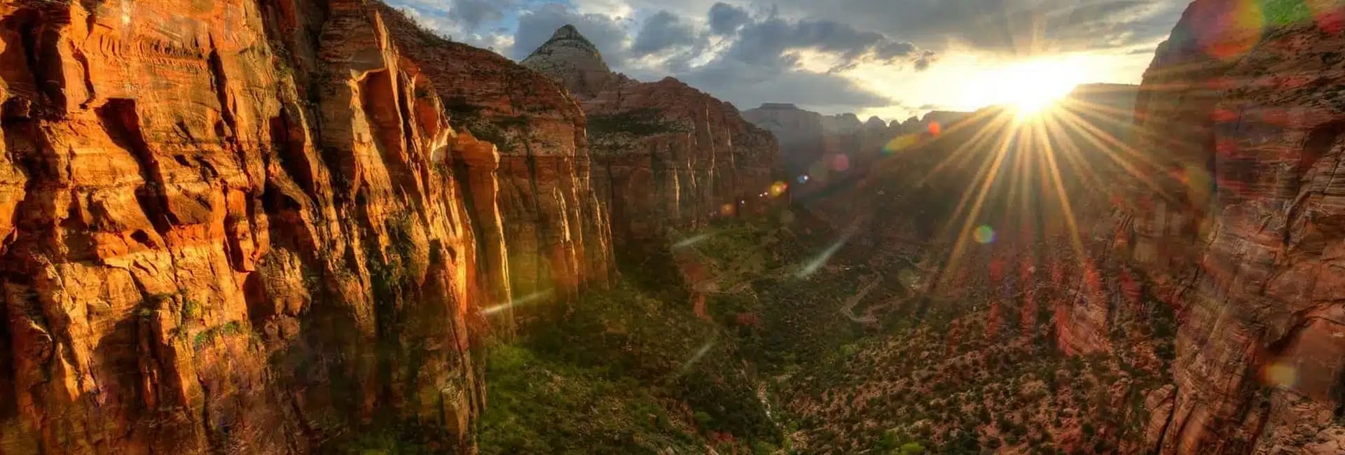 Sunset illuminating the rugged cliffs of a canyon.