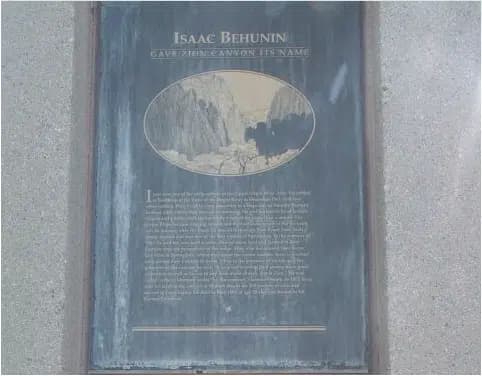 A historical plaque about Isaac Behunin, detailing his significance in naming a canyon.