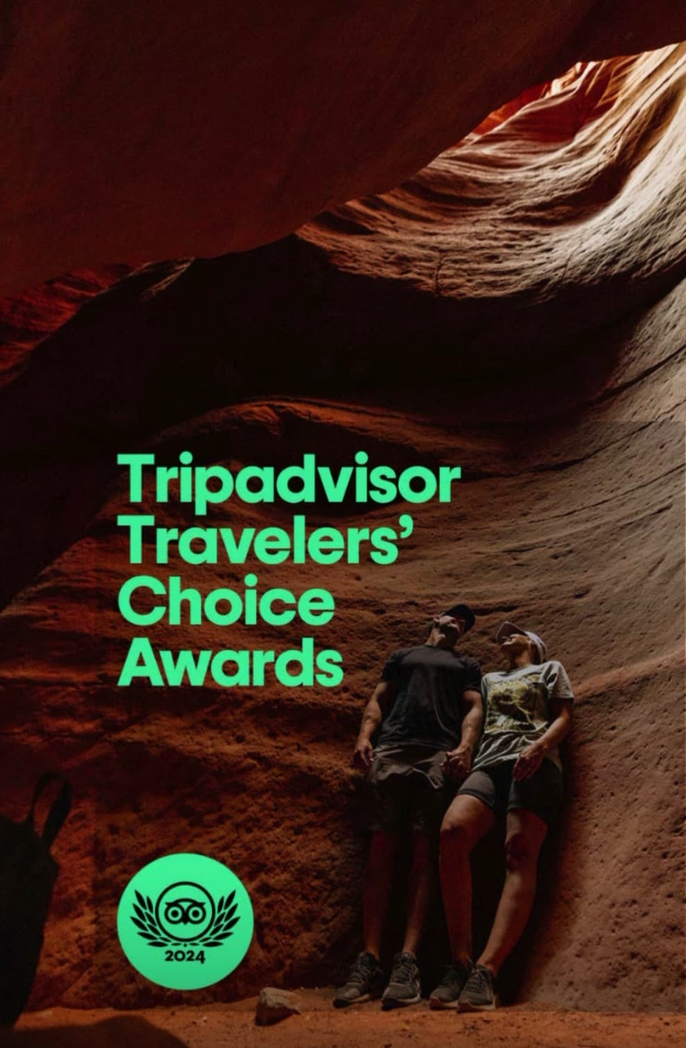 A couple stands together in a narrow canyon, promoting the 2024 Tripadvisor Travelers' Choice Awards.