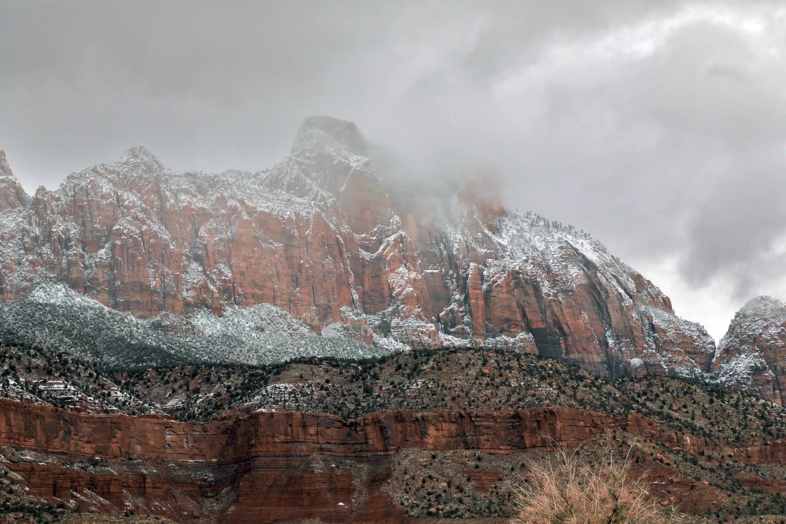 Majestic snow-capped mountains under a cloudy sky.