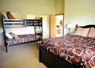 A comfortable bedroom featuring a double bed and a bunk bed.