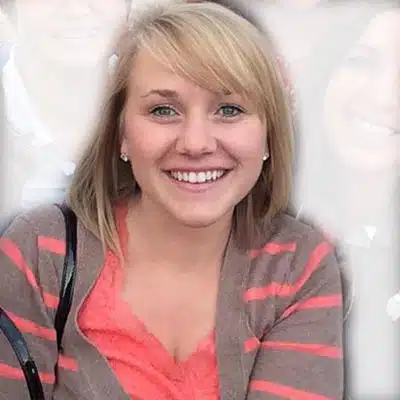 A smiling young woman with blonde hair and a striped cardigan poses for the camera.