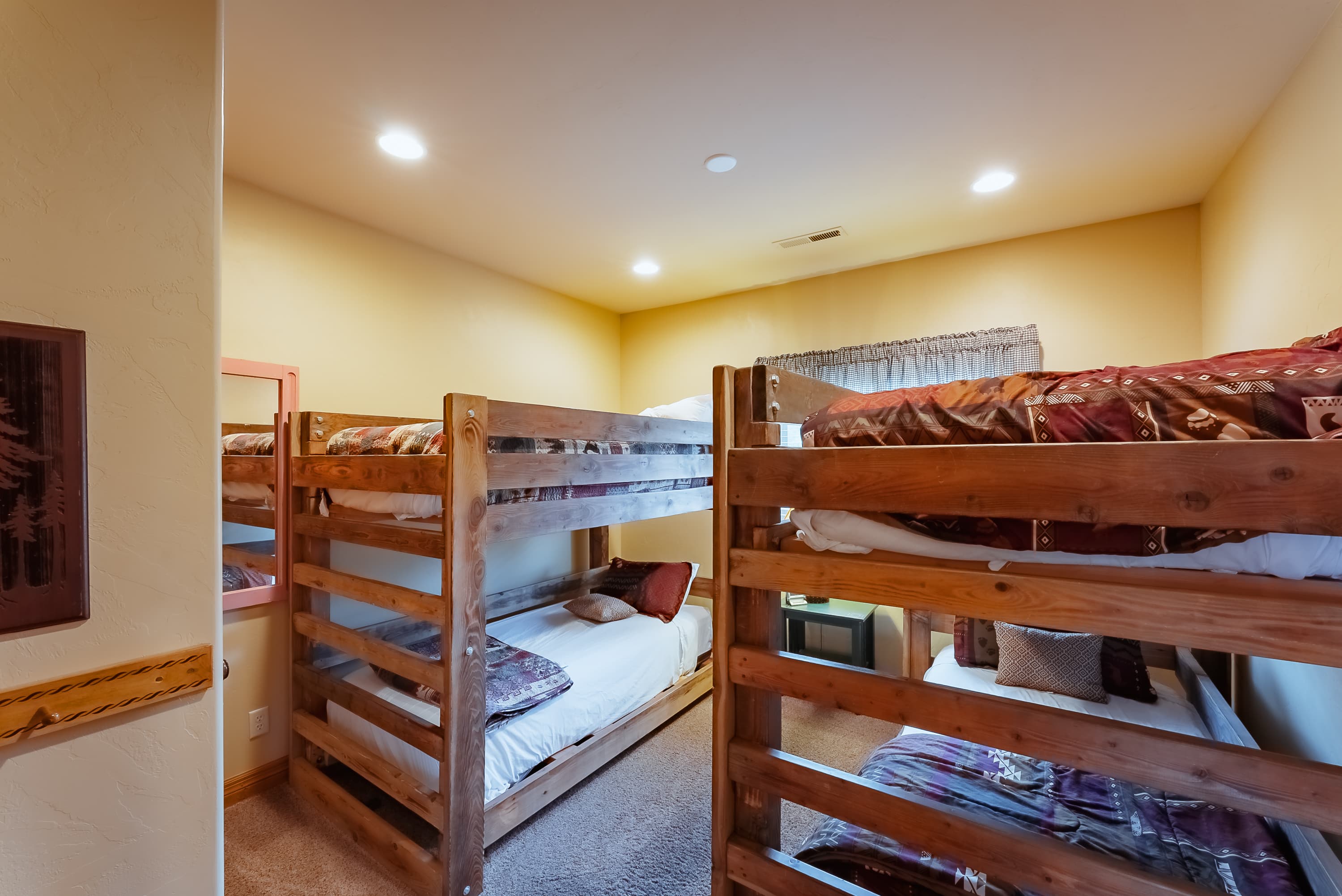 Wooden bunk beds in a cozy, softly lit room.