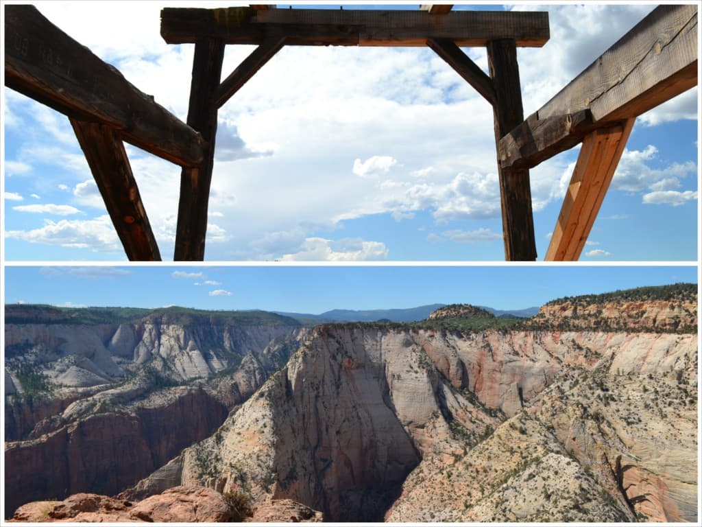 A wooden structure frames a dramatic view of a canyon landscape under a bright sky.