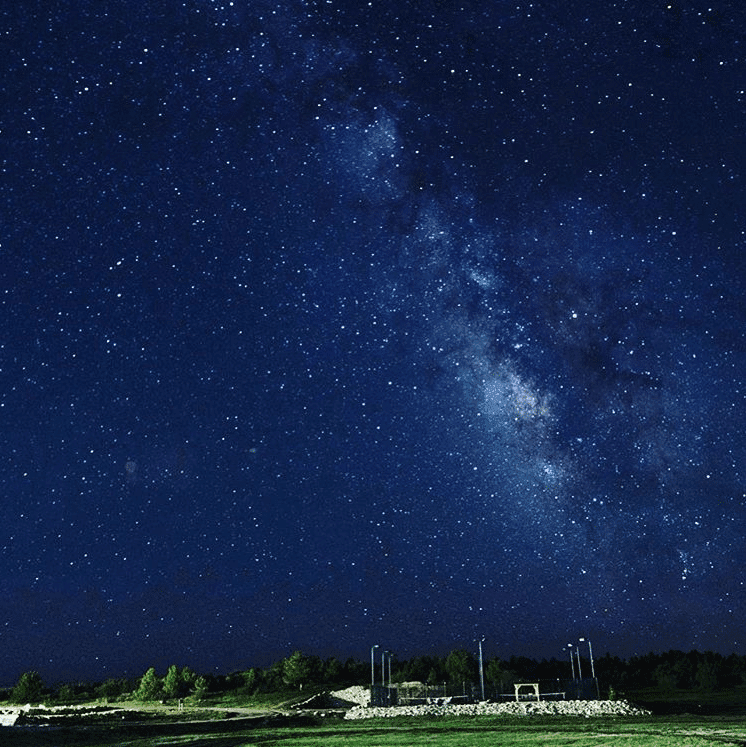 A star-filled night sky with the Milky Way visible.