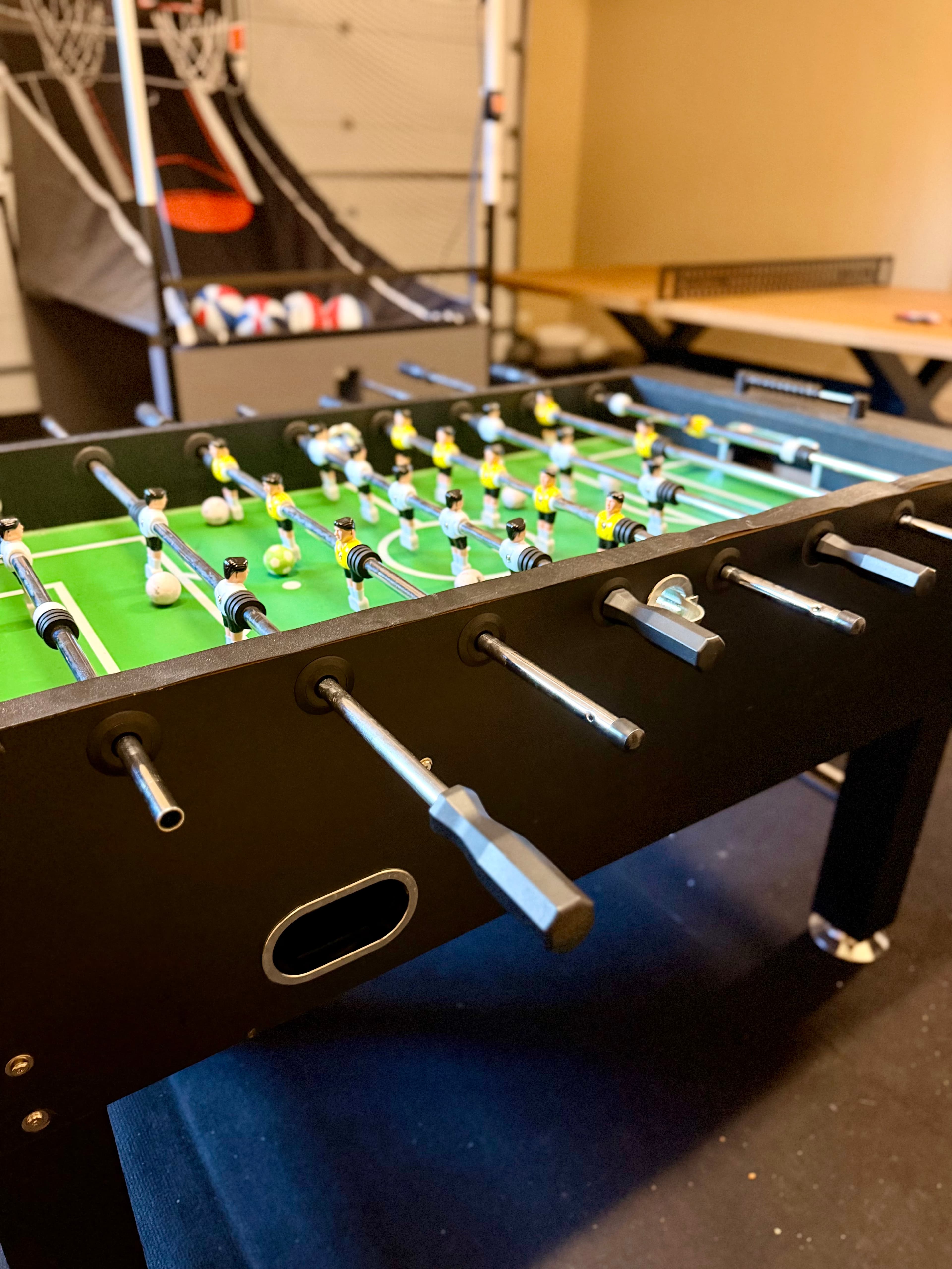 A close-up view of a foosball table with players in action.