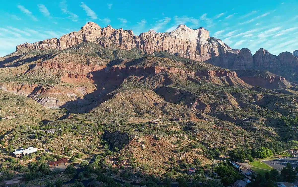 A panoramic view of rugged mountains under a clear blue sky.