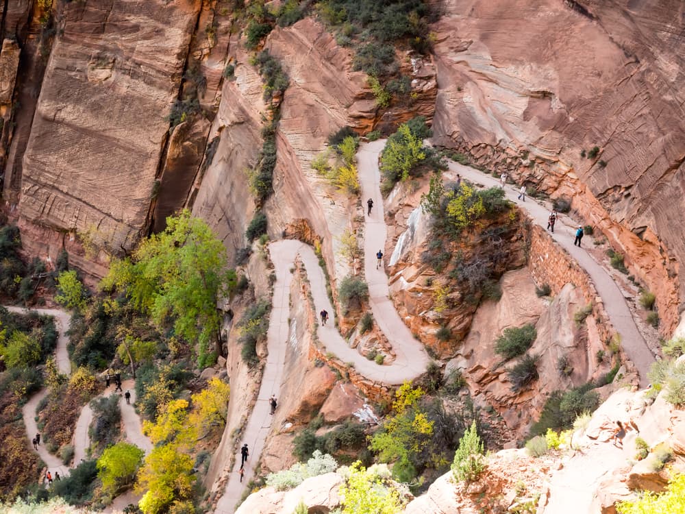 Winding trail through a mountainous landscape with hikers.