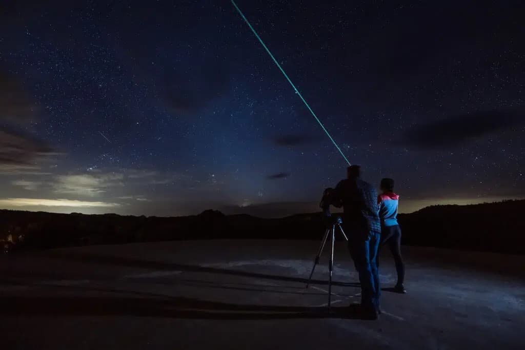 People looking at the night sky with a telescope
