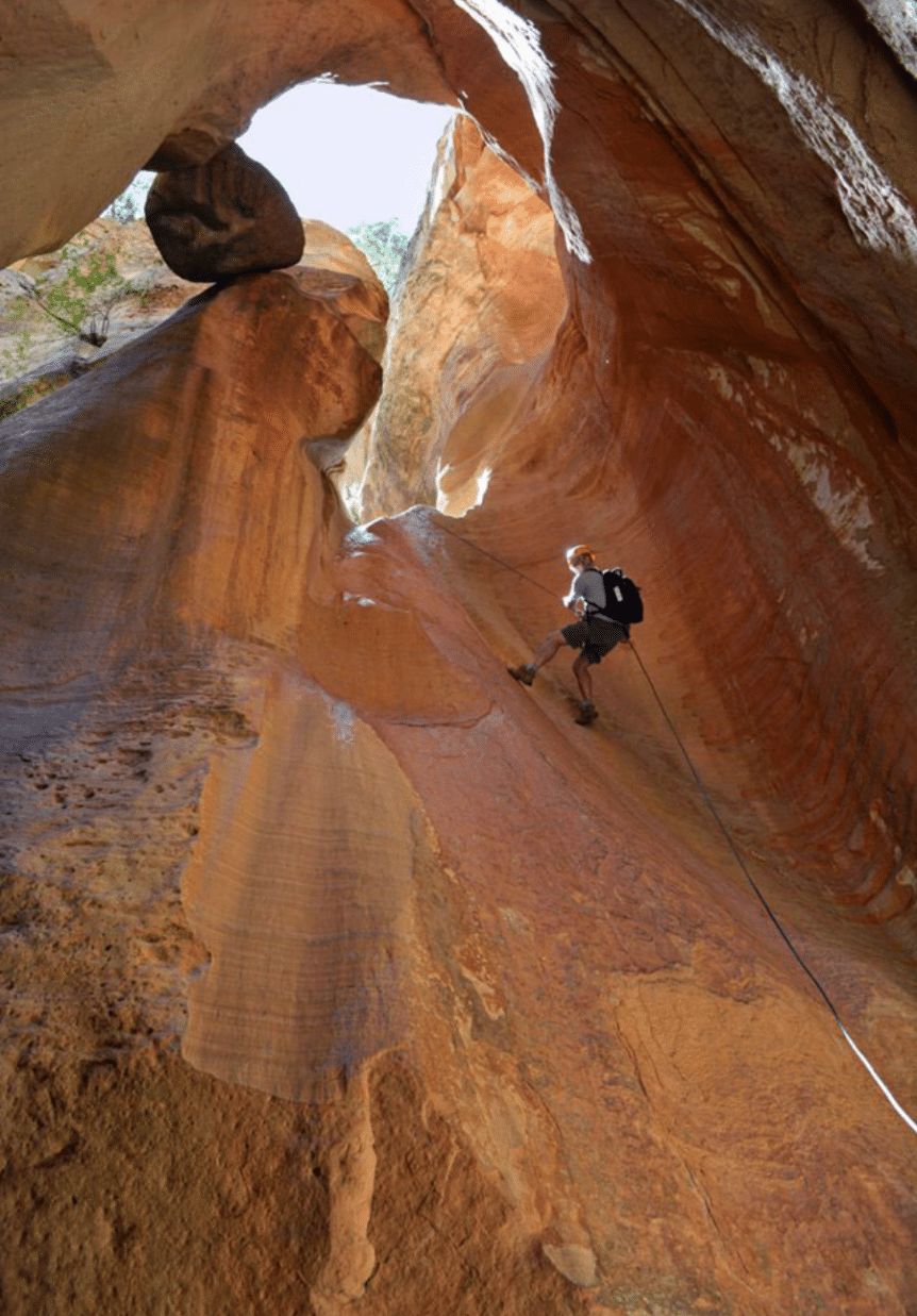 rock climber repelling rock face in Heaps Canyon Zion National Park