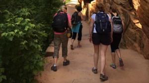 A group of women hike together on the trail to angels landing at Zion national park