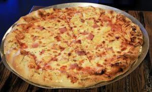 image of a Hawaiian pizza with pineapple and ham from Zion Ponderosa restaurant near Zion National Park