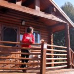 Couple lounging on deck of log cabin near Zion