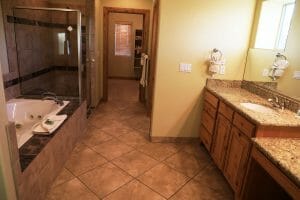a clean tiled bathroom with a large jet tub and spacious shower inside of a vacation home at Zion Ponderosa Ranch