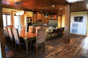 a clean wood floored and rustic kitchen and dining room area inside of a vacation home at Zion Ponderosa Ranch