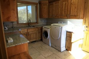 a clean laundry room and sink area inside of a vacation home at Zion Ponderosa Ranch