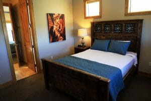 A neatly made full sized bed inside of a vacation home at Zion Ponderosa Ranch