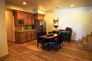 a small wood floored kitchen and dining area inside of a vacation home at Zion Ponderosa Ranch