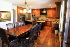a wood floored and warm kitchen and dining area inside of a vacation home at Zion Ponderosa Ranch