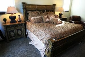 a neatly made queen sized bed inside of a vacation home at Zion Ponderosa Ranch