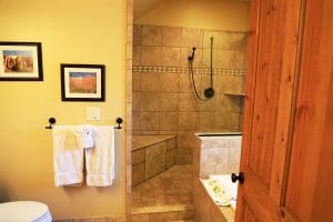a clean tiled open shower inside of a vacation home at Zion Ponderosa Ranch