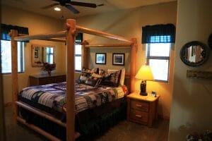 a neatly made 4 post queen sized bed inside of a vacation home at Zion Ponderosa Ranch