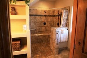 a clean and tiled open shower in the bathroom inside of a vacation home at Zion Ponderosa Ranch