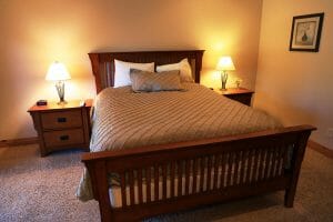 A neatly made queen sized bed inside of a vacation home at Zion Ponderosa Ranch
