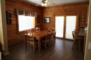 a clean and wooded dining room inside a vacation home at Zion Ponderosa Ranch