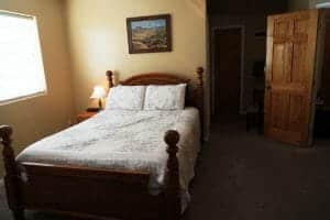 a neatly made bed inside a vacation home at Zion Ponderosa Ranch