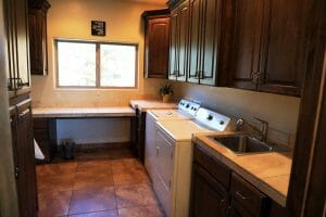 a clean laundry room with counterspace and a sink inside a vacation home at Zion Ponderosa Ranch