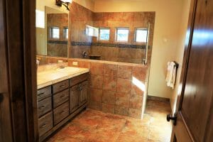 a clean and tiled bathroom with an open shower inside a vacation home near Zion National Park