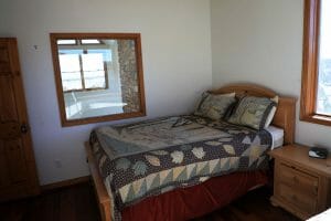 a neatly made double bed in a vacation home near Zion national park