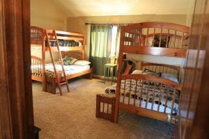 a bedroom with 2 sets of full sized bunk beds in a vacation home near Zion national park