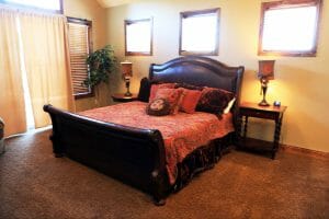a lavishly made king sized bed in a spacious bedroom in a vacation home near Zion national park