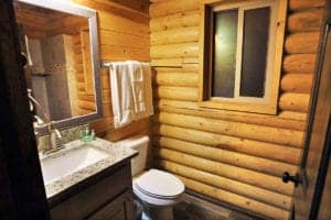 a wood walled bathroom inside a cabin suite at Zion Ponderosa Ranch