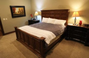 A spacious bedroom with a neatly made king sized bed at a vacation home near Zion National Park