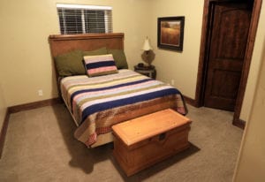a neatly made double bed in a vacation home near zion national park