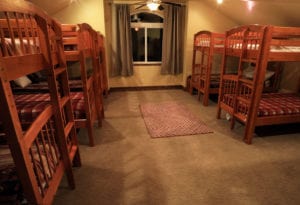 a bedroom with 5 sets of bunk beds at a vacation home at zion ponderosa ranch