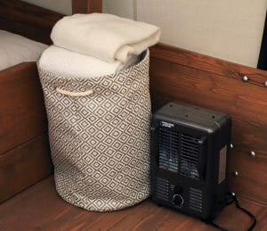 a container with towels and a small electric heater in a vacation home at zion ponderosa ranch