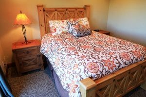 a neatly made full sized bed in a spacious bed room in a vacation home near zion national park