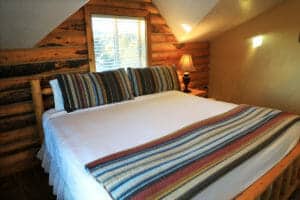 a king sized bed in a cabin at zion ponderosa ranch