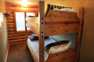 a bunk bed in a small bedroom in a cabin at zion ponderosa ranch