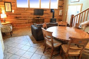 an open dining area nd living room in a small bedroom in a cabin at zion ponderosa ranch