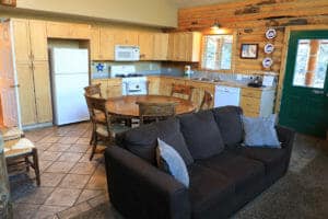an open dining area and living room in a small bedroom in a cabin at zion ponderosa ranch