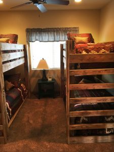 a bedroom with 2 bunk beds in a vacation home at zion ponderosa ranch